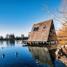 Une cabane sur l'eau avec le toit en pente.